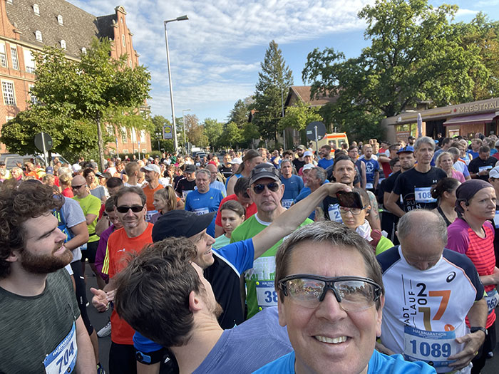 Selfie über den Kopf hinweg in den Startbereich mit wartenden Läuferinnen und Läufern