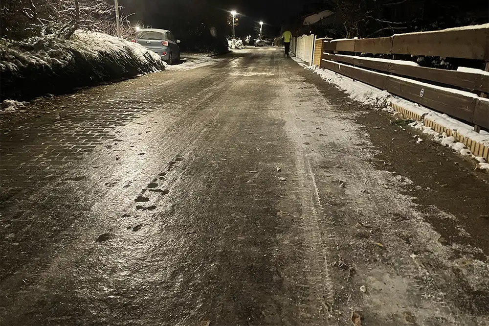 Vereiste Straße, das Eis glänzt im Laternenlicht