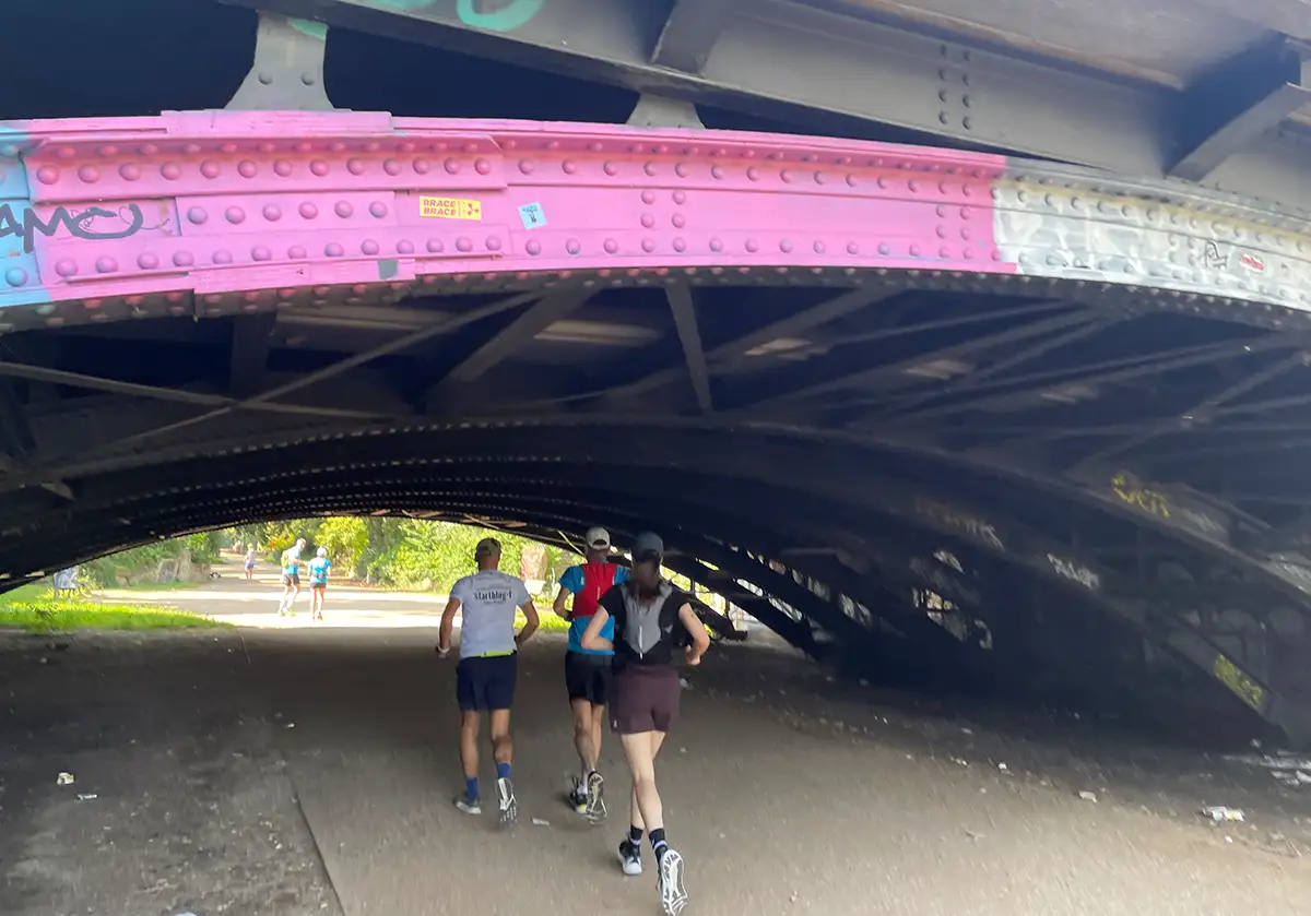 Laufgruppe unter einer Stahlbrücke