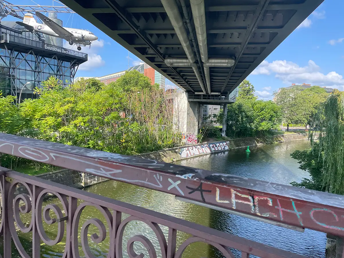 Blick von einer Brücke unterhalb der Hochbahn auf das Technikmuseum mit dem Rosinenbomber über dem Eingang