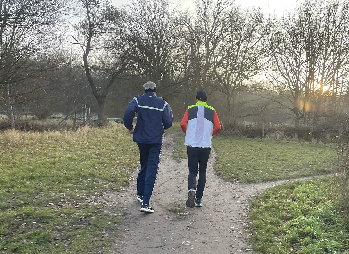 Zwei Läufer kurz vor einem Wäldchen