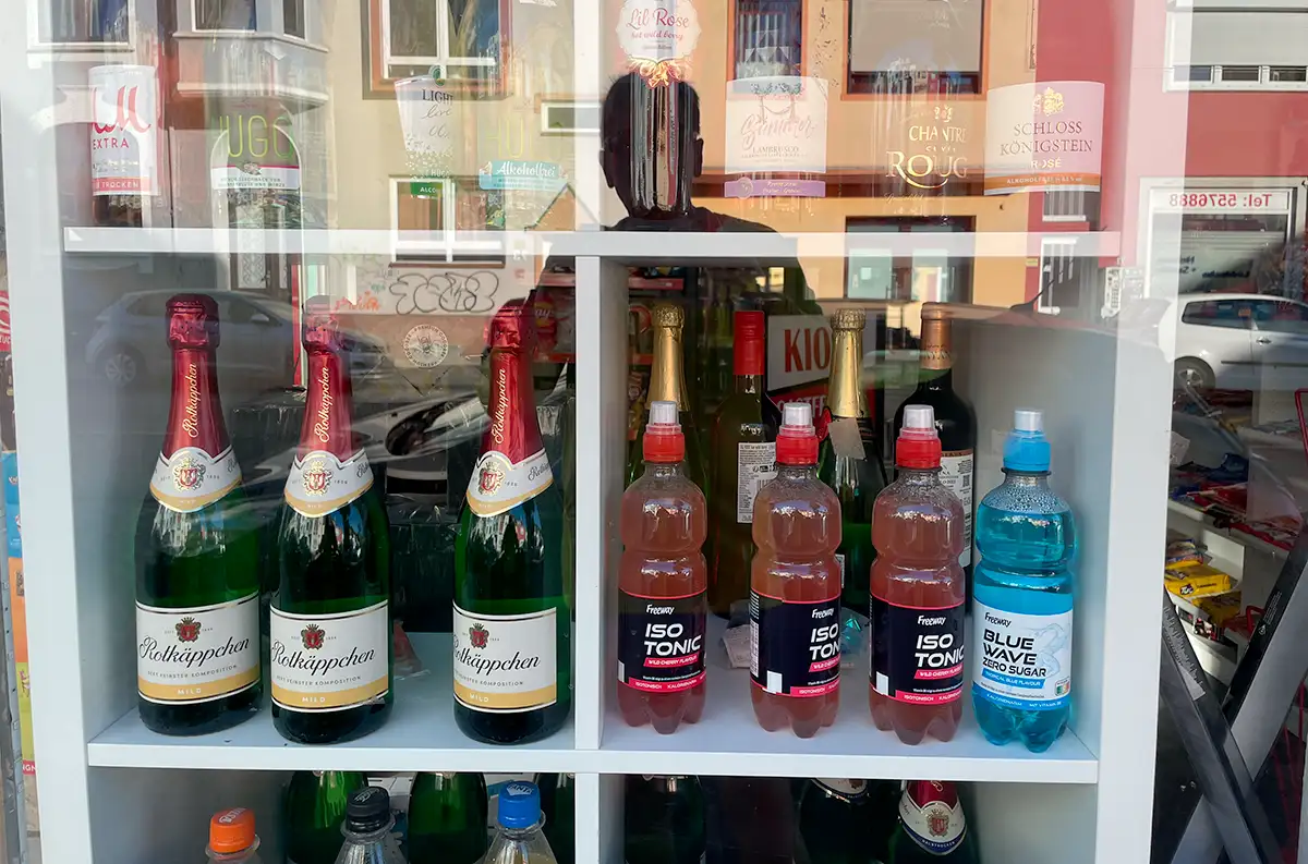 Schaufenster mit isotonischen Getränken direkt neben zahlreichen alkoholischen Getränken