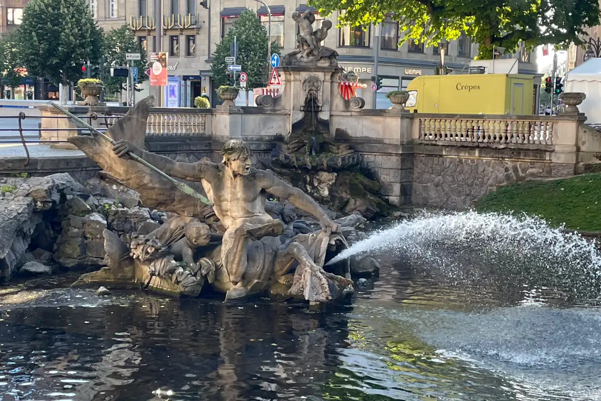 Triton-Brunnen mit wasserspeiendem Fisch