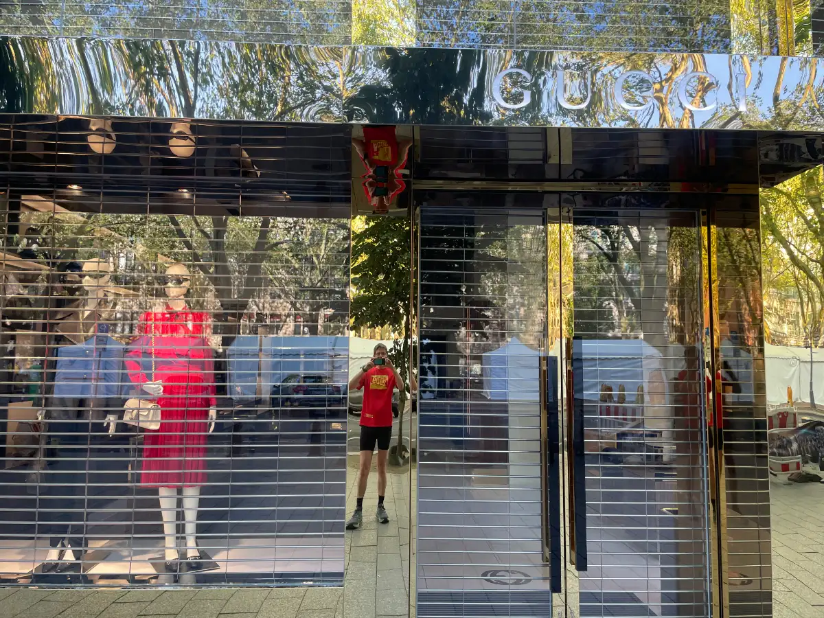 Geschäft von Gucci, in der goldenen Fassadenverkleidung spiegelt sich der Läufer