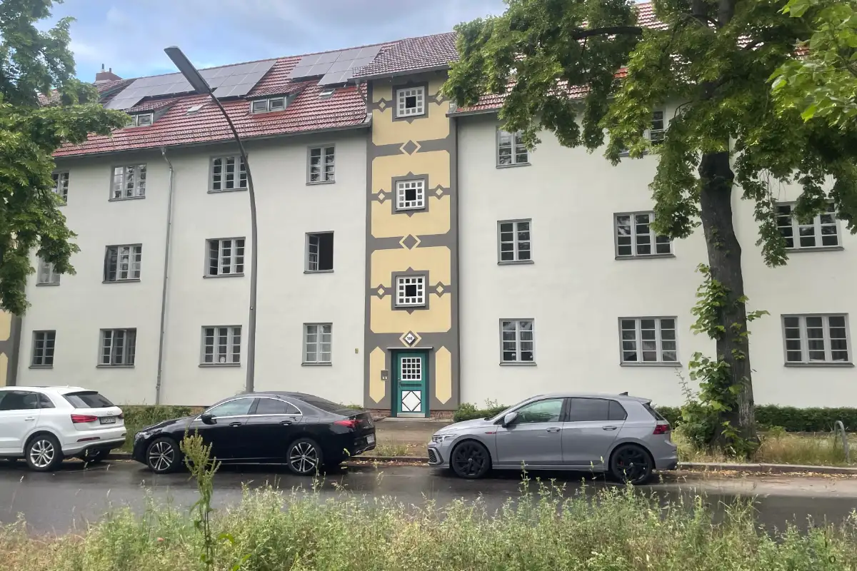 Mehrstöckiges Haus mit schön bemalter Fassade im Bereich des Eingangs und Treppenhauses