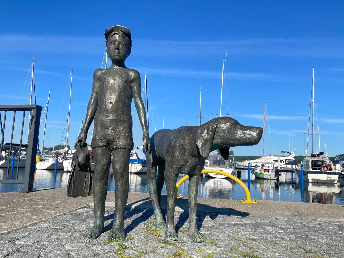 Skulptur eines Badejungen mit Hund